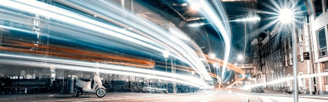 Image of street light motion, blurred motion light trail at night of a horizontal street 