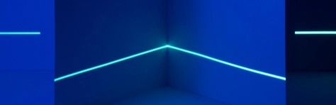 Modern blue background with neon LED light bar. Dark room with indoor blue lighting.