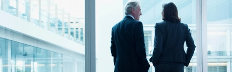 Two Mazars partners looking out of building window