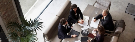 Image of a group of financial advisors sitting around a table in a meeting room 