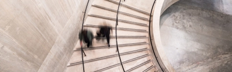 Busy business people walking down office stairs