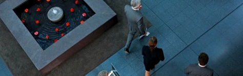 A top view of businesspeople walking through a lobby heading for a meeting. 