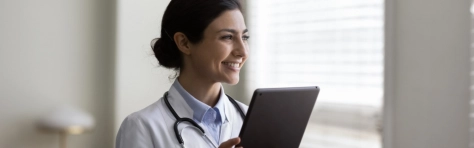 An image of a doctor looking on a tablet 