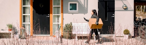 Woman taking parcel to social housing
