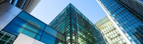 Tall glass buildings representing Financial reporting of European banks