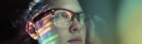 Woman with glasses looking into the distance, code, computer coding, technology, AI, artificial intelligence, computer science, network, data, engineer