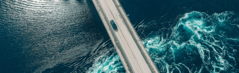 An image of a car on a road driving over water