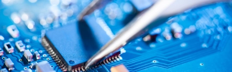 Electronic technician holding tweezers and assemblin a circuit board. - Semiconductor - Computer Chip Electronics Industry - Circuit Board - Electrical Equipment - Repairing - Computer - Technology Electrical Component - Engineer - Production Line CPU - Laptop - Service - Engineering