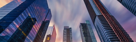 A low angle view of modern financial skyscrapers rising straight up