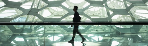 Man walking alone in modern corridor hallway, airport, travelling, business, smart
