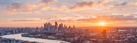 London City skyline with sun rise / sun set. Canary wharf central London district with river thames