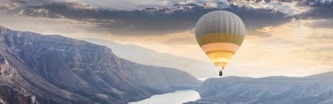 Hot air balloons flying over the Botan Canyon in Turkey. Mountain range, nature, hills, valleys, rock.