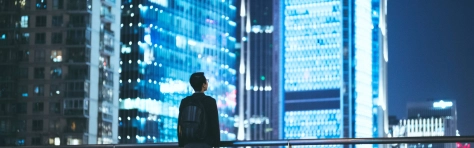 An image of a businessman looking out at a city