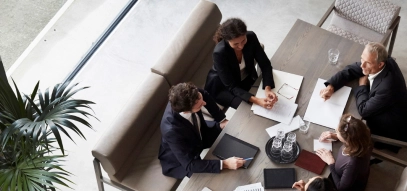 Image of a group of financial advisors sitting around a table in a meeting room 